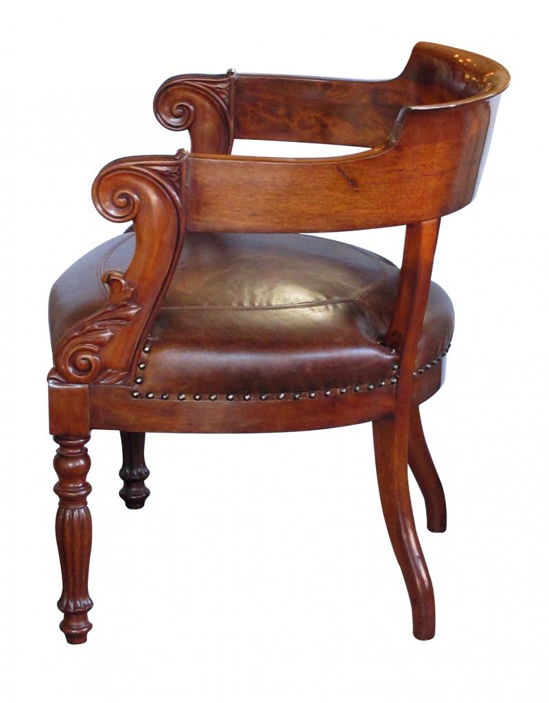 A dramatically-carved French restoration barrel-back desk chair