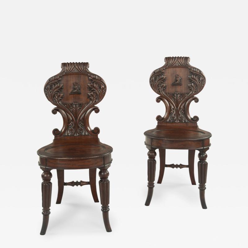A fine pair of Regency mahogany armorial hall chairs attributed Gillows