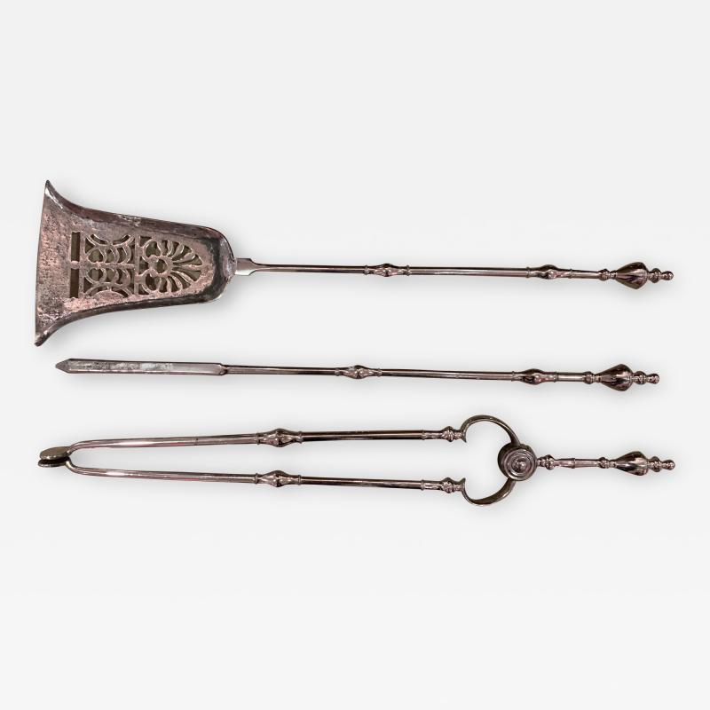 A fine set of silver steel fire tools