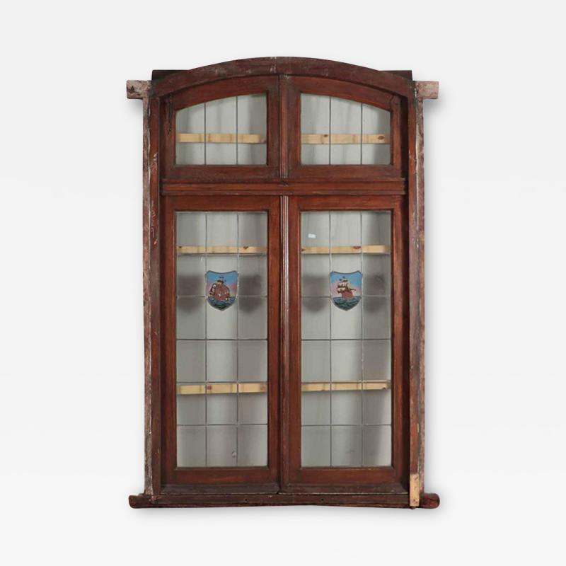 A four panel mahogany window set in frame with leaded glass having ship motif 