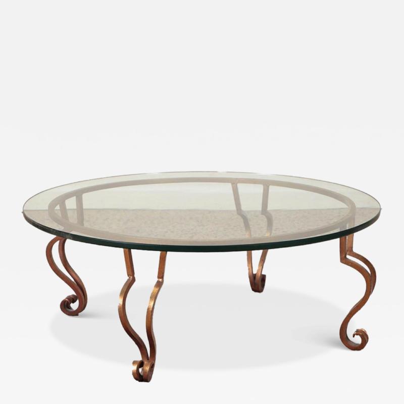 A gilt iron glass top coffee table in the manner of Ramsay circa 1975 