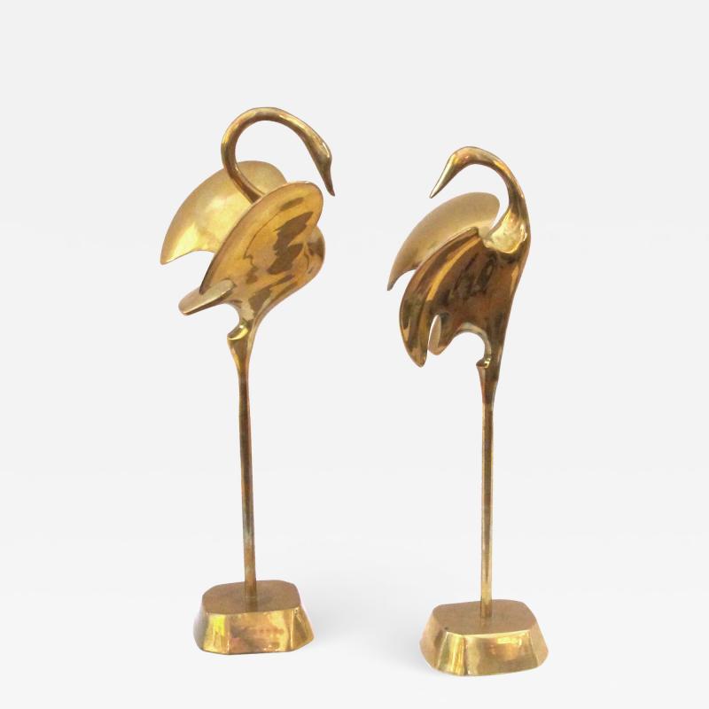 A graceful pair of stylized solid brass cranes