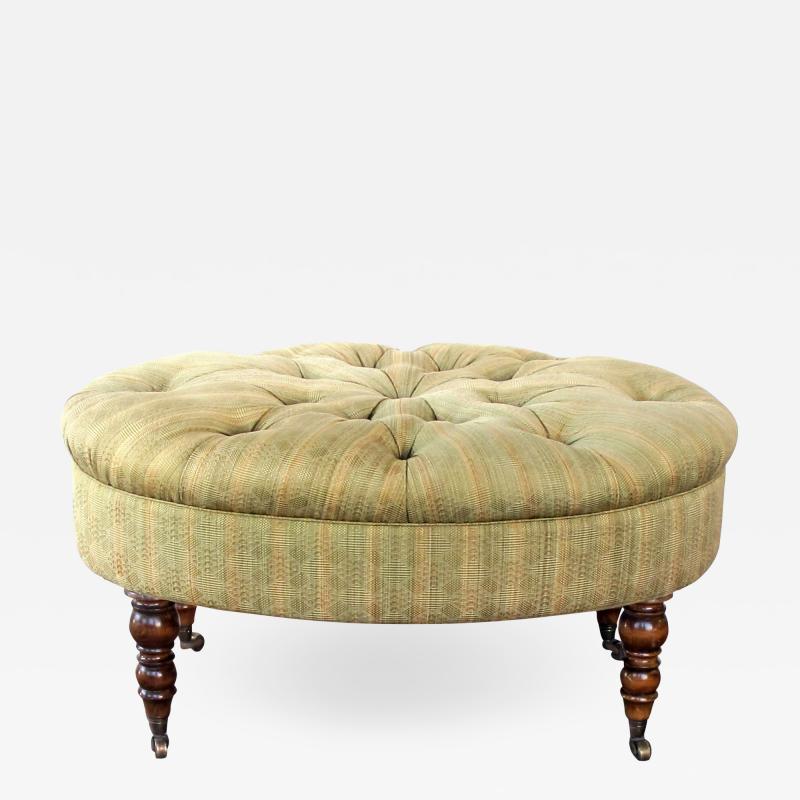 A handsome English oval ottoman stool with turned legs and casters