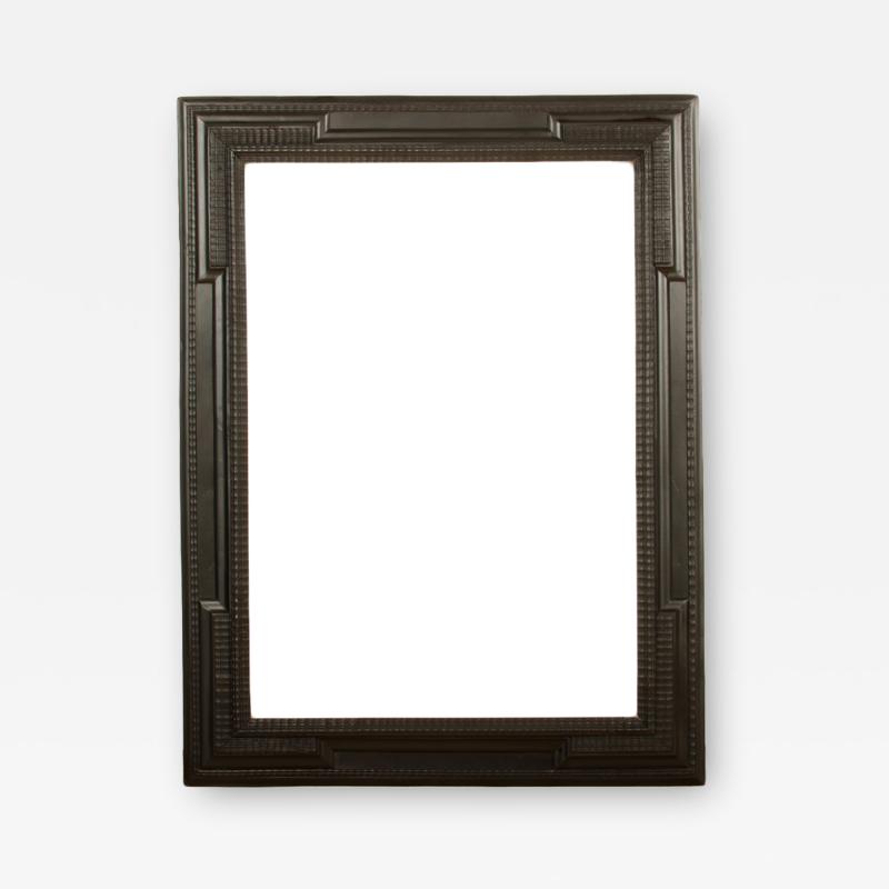 A large 19th C Dutch style ebonized carved wood frame mirror