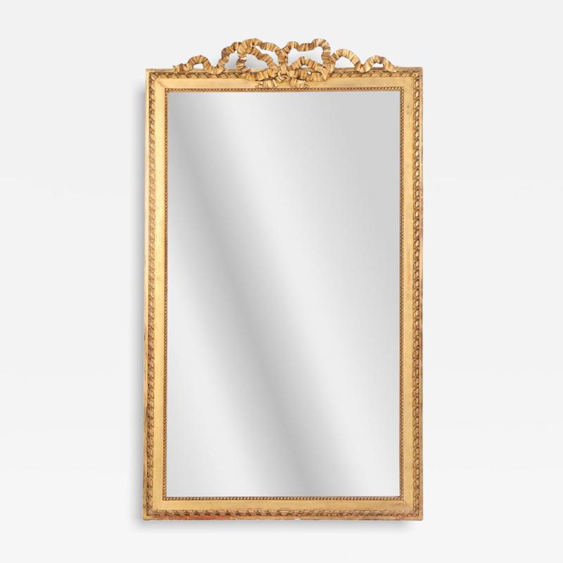 A large French Neoclassical Revival giltwood mirror with ribbon crest C 1890 
