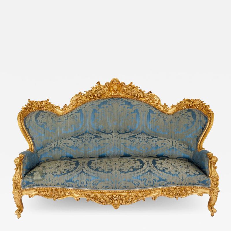 A large Rococo revival carved giltwood sofa