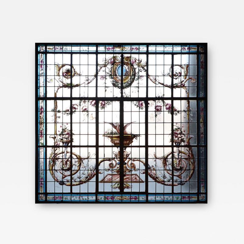 A large painted and leaded glass window in iron frame circa 1900 