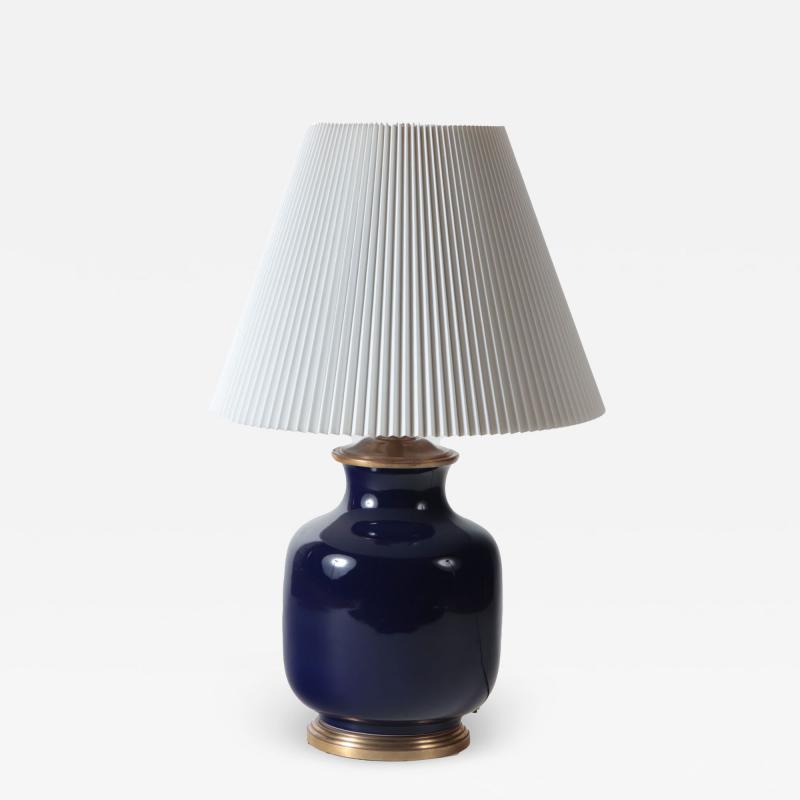 A large single blue porcelain table lamp with gilt base