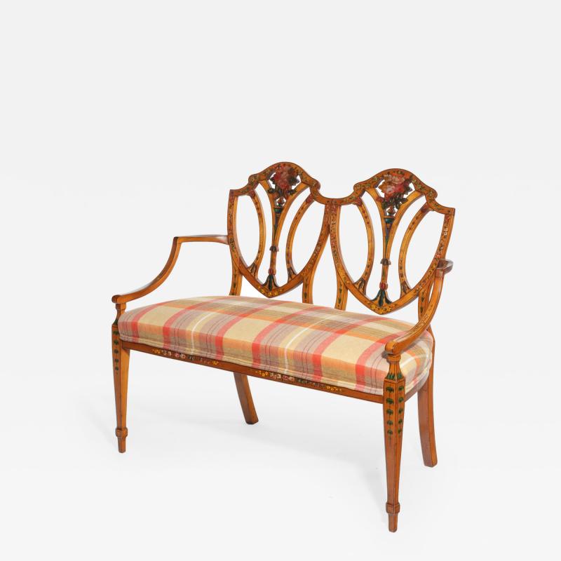 A late Victorian Sheraton revival painted satinwood two seater settee