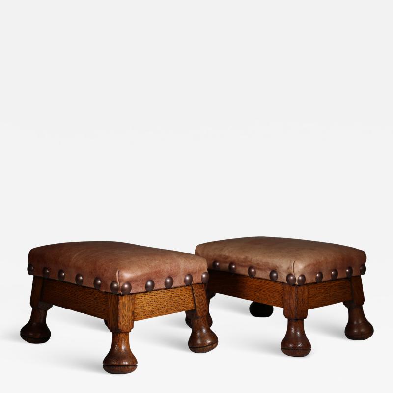 A little pair of Aesthetic Movement oak Thebe stools with leather studded seats