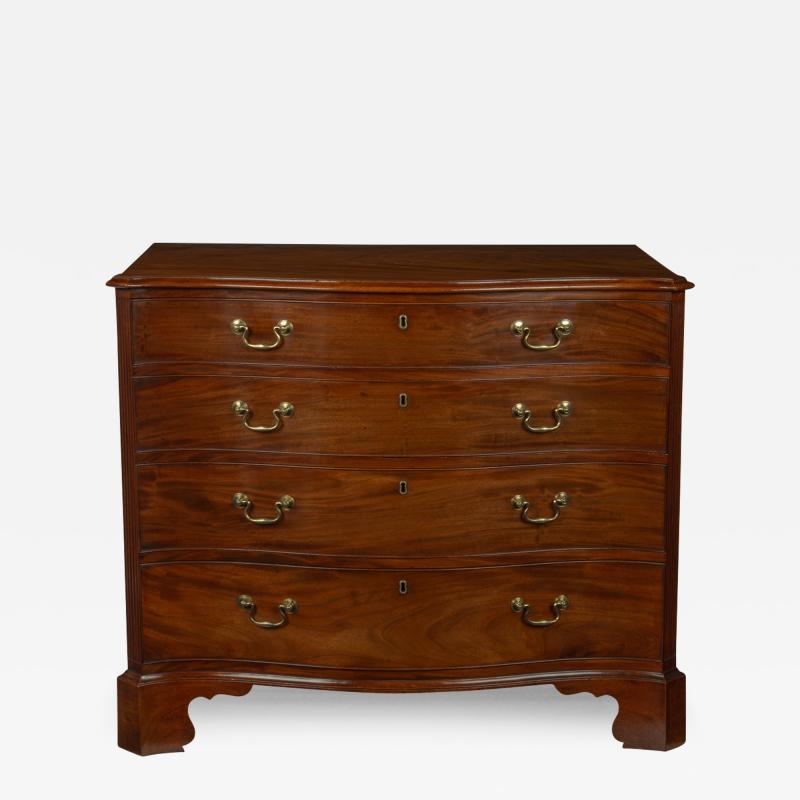 A mahogany four drawer serpentine chest of drawers