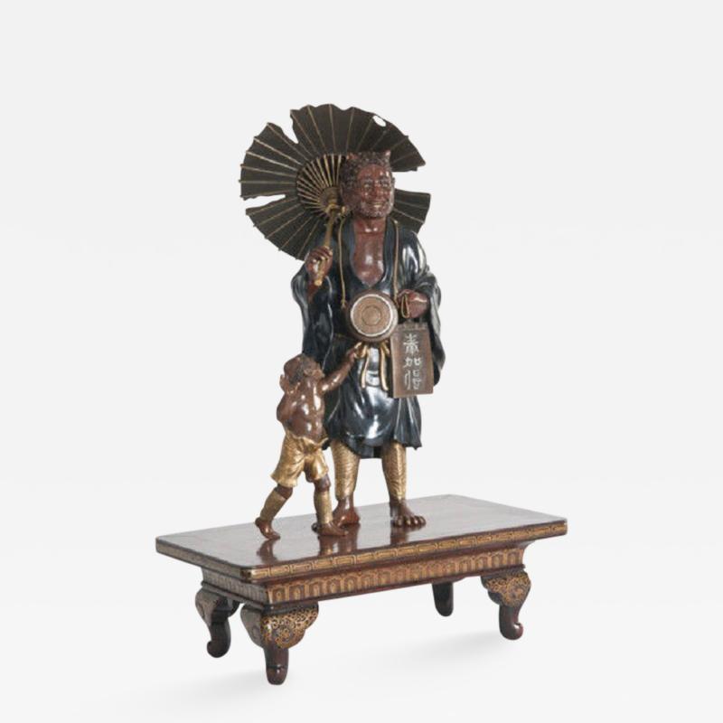 A meiji period bronze of an Oni holding a parasol