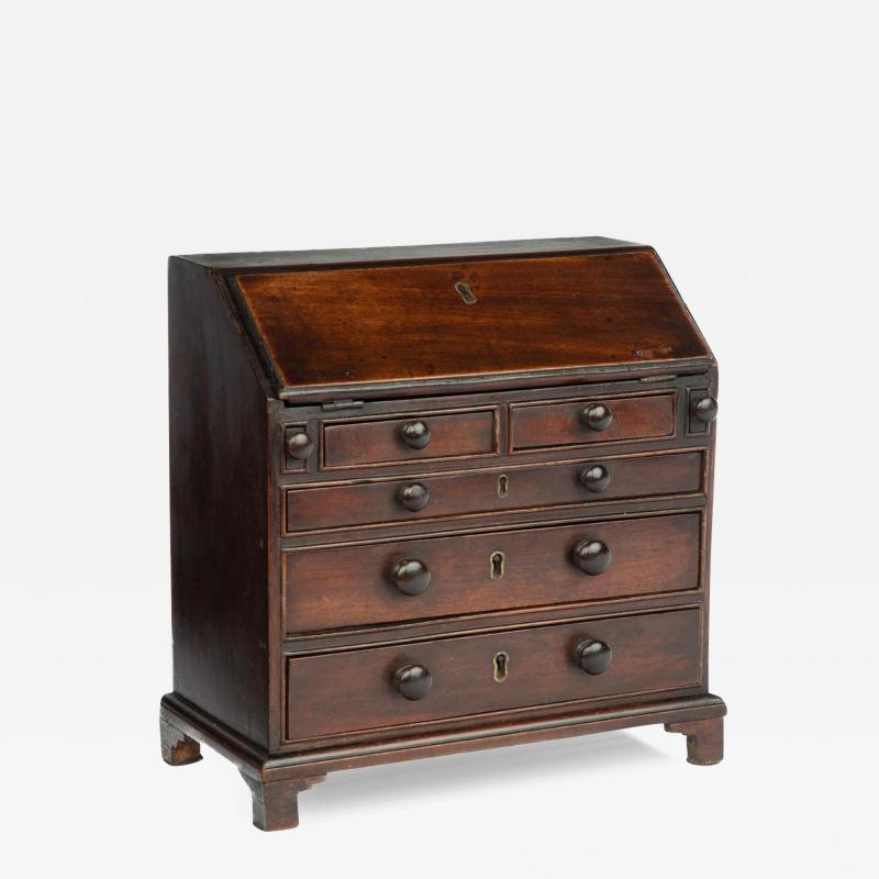 A miniature George III mahogany bureau