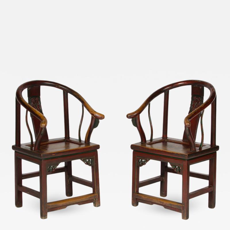 A pair of 19th Century Chinese painted horseshoe back armchairs