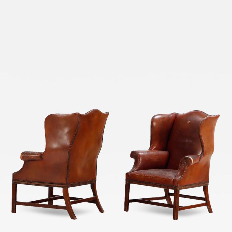 A pair of Chippendale style leather wing chairs C 1910 