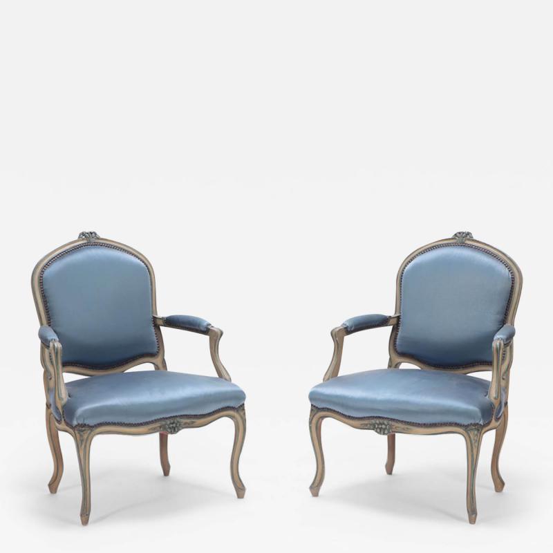 A pair of French Louis XV style open armchairs having carved frames circa 1920 