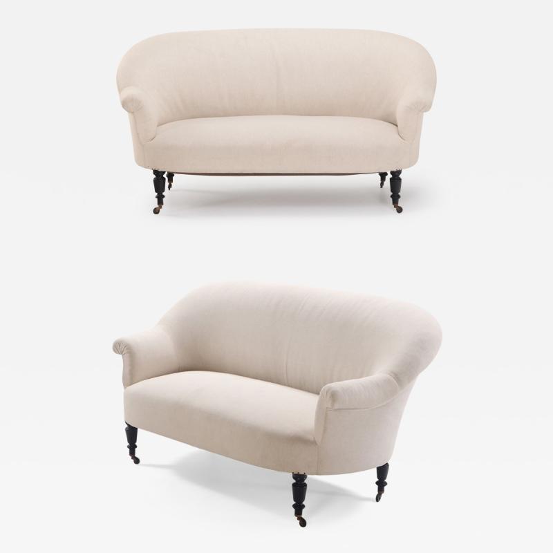 A pair of French Napoleon III sofas with continuous backs circa 1860 