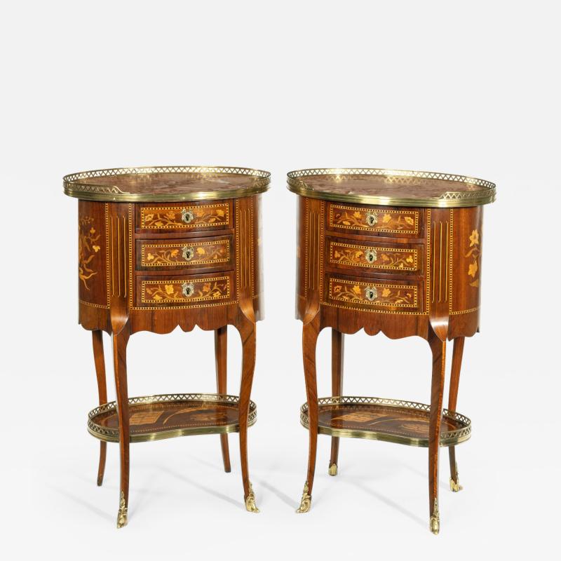 A pair of French rosewood oval marquetry bedside tables with marble tops