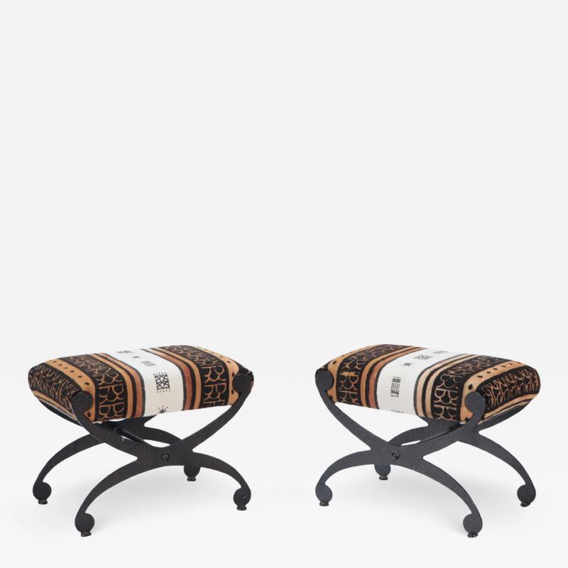 A pair of Modern painted iron and upholstered benches with interesting fabric 