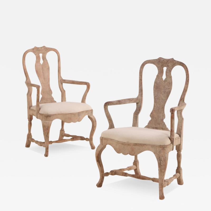 A pair of Swedish Rococo carved and whitewashed walnut armchairs 18th C 