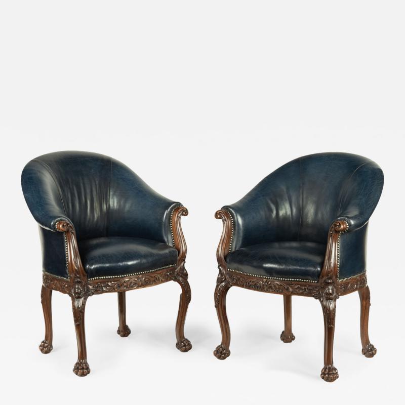 A pair of Victorian blue leather and walnut tub chairs