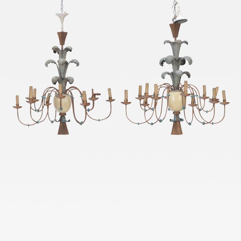 A pair of carved wood and painted metal chandeliers circa 1960 