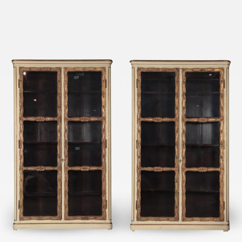 A pair of cream painted and parcel gilt large bookcases French 19th C
