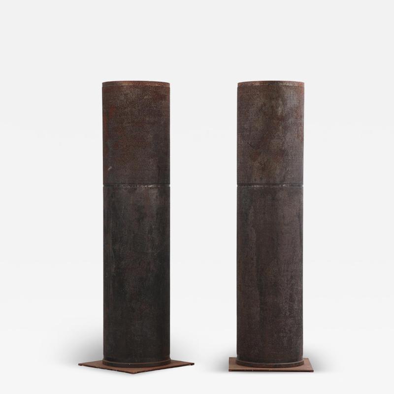 A pair of dimpled iron industrial tubes fitted as lamps 