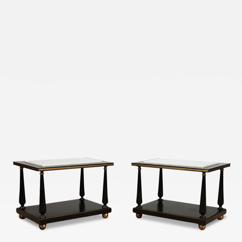 A pair of ebonized and gilt marble top end tables on ball feet circa 1950 