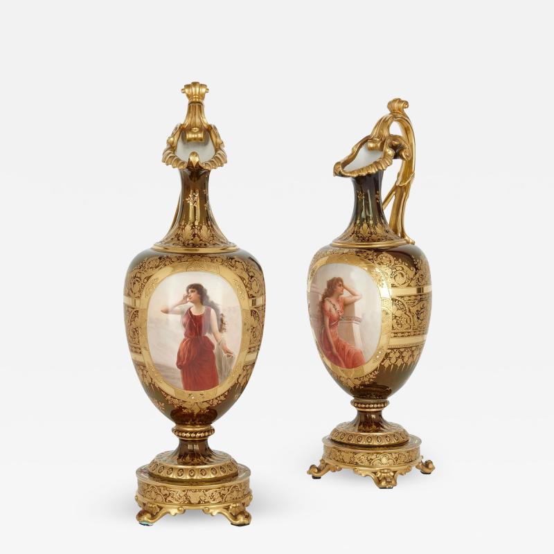 A pair of large Royal Vienna gilt and painted porcelain ewers