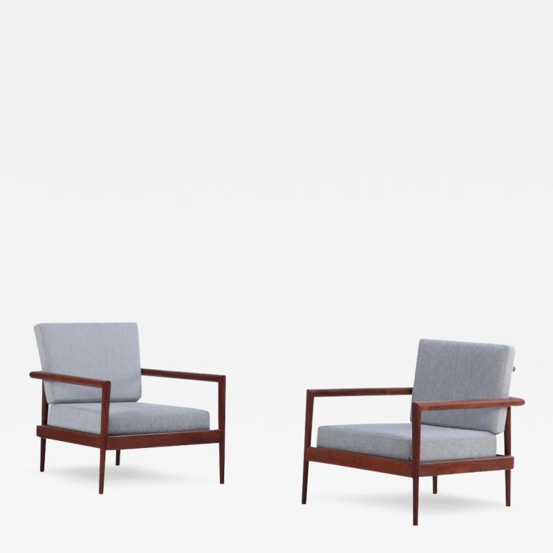 A pair of lounge chairs with Windsor style backs designed by Edmund Spence 