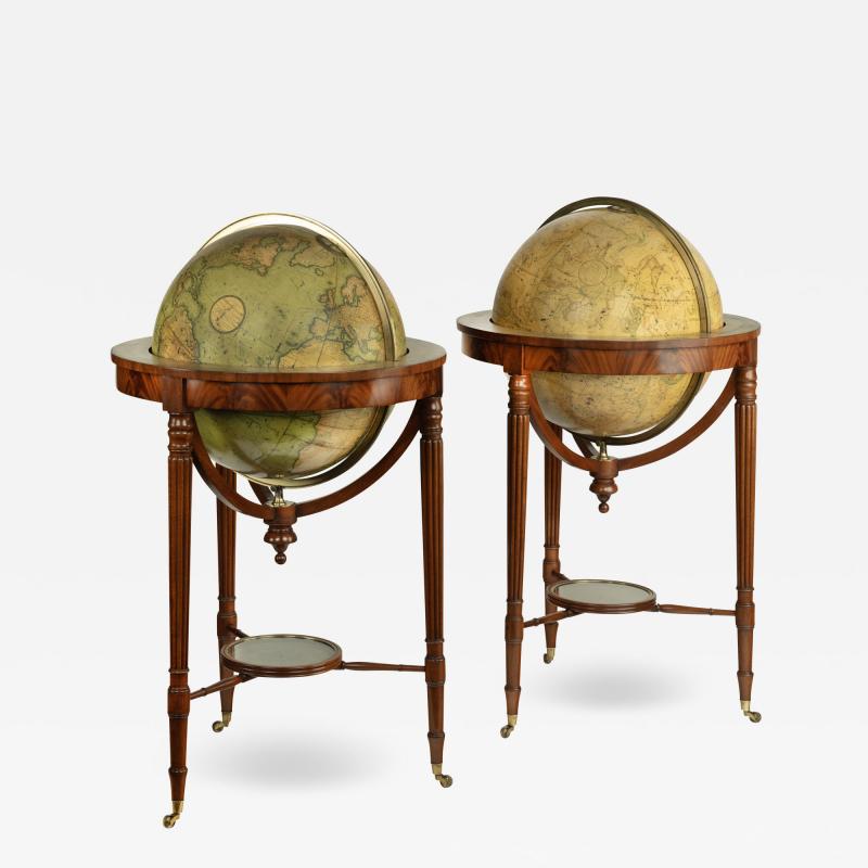 A pair of mahogany Regency 21 inch globes by J W Cary dated 1799 and 1819