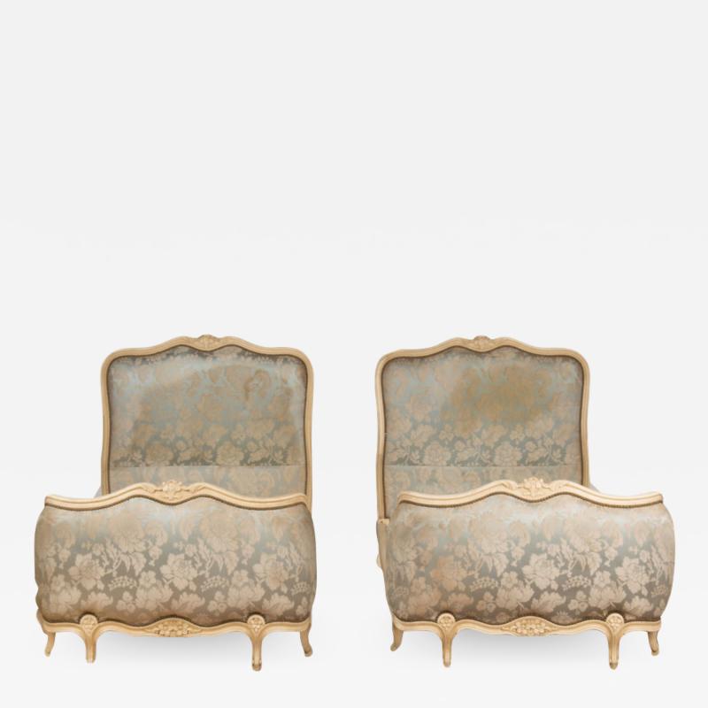 A pair of painted and carved French Louis XV style twin beds circa 1940