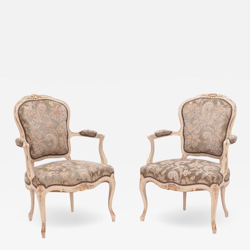 A pair of painted and giltwood French upholstered open armchairs Louis XV style