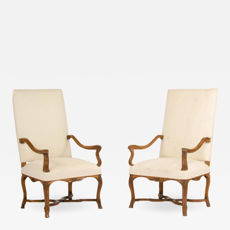 A pair of tall French walnut armchairs circa 1900