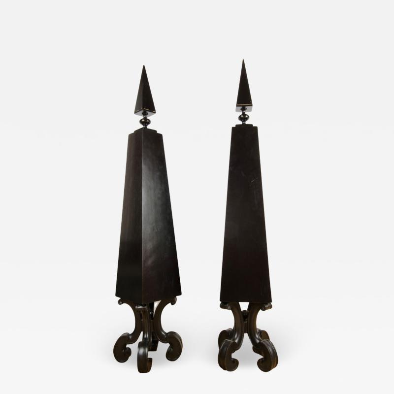 A pair of tall black decorative obelisks