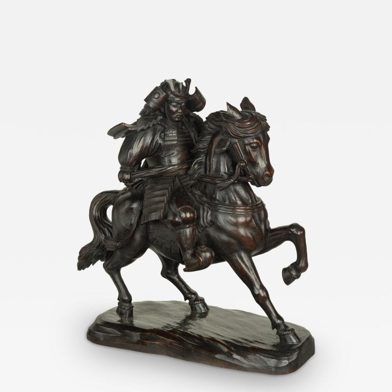 A powerful Japanese equestrian wood carving of a samurai by Yoshida Issen Isshun