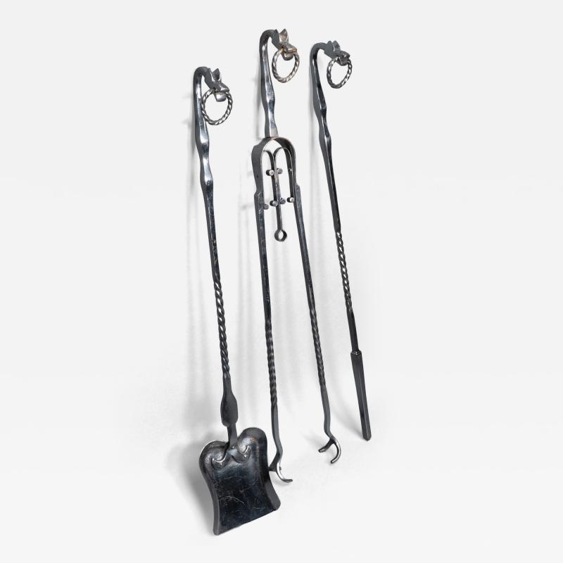 A set of Arts Crafts Cotswold School polished steel hand wrought fire utensils