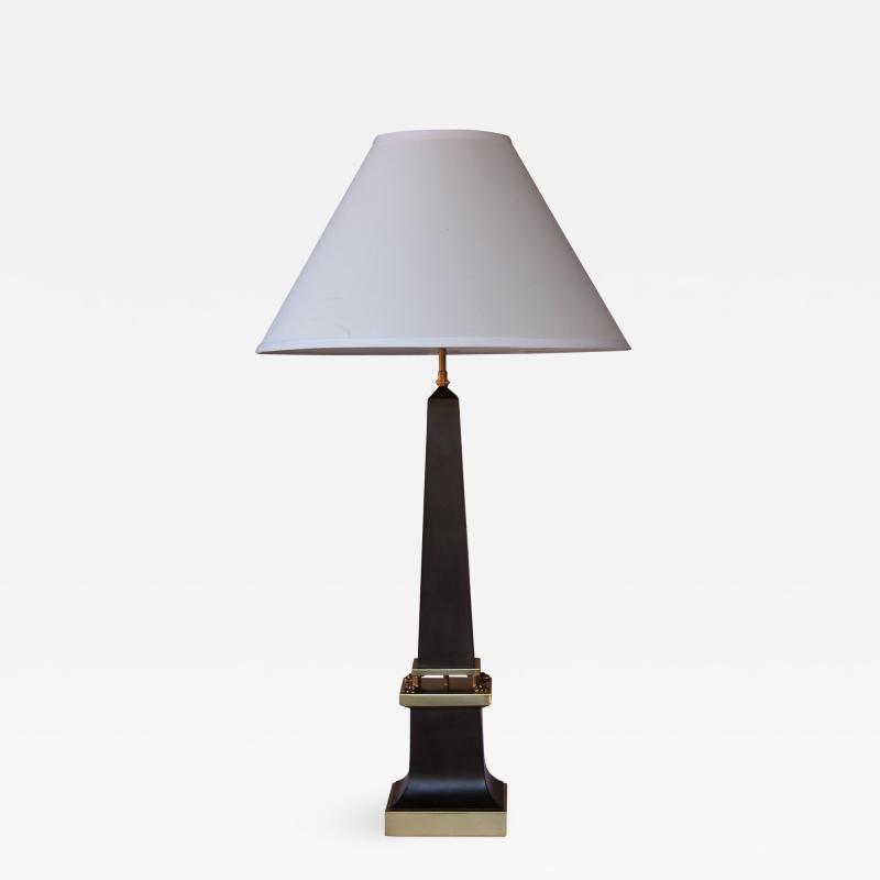 A sleek French 1940s black painted tole obelisk form lamp with brass mounts