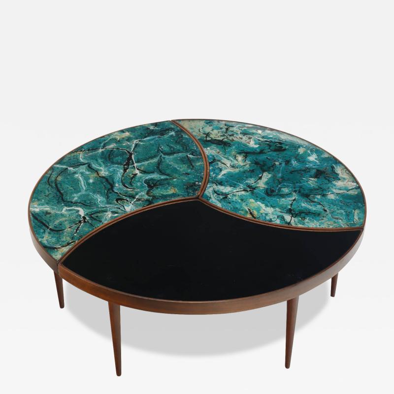 A three part biomorphic marbleized glass and walnut circular coffee table 