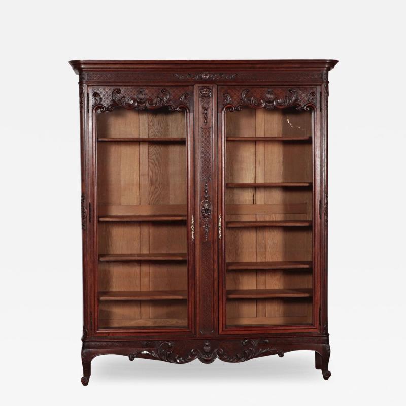A two door Louis XV style French oak bookcase Circa 1900
