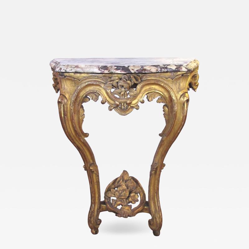 A well carved Italian rococo gilt wood wall console table with marble top