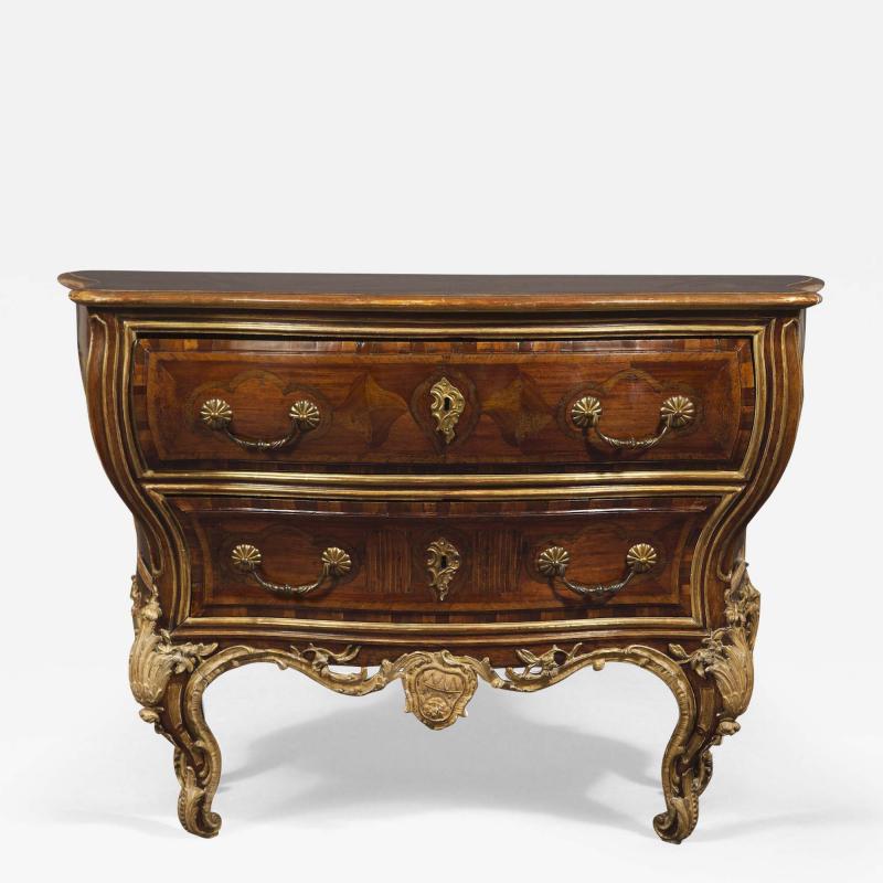 AN EXTRAORDINARY WALNUT AND EXOTIC WOODS INLAID PARCEL GILT COMMODE