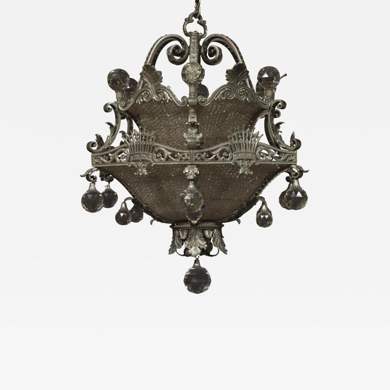 AN UNUSUAL FINELY CAST AND SILVERED BRONZE FACETED GLASS MOUNTED CHANDELIER