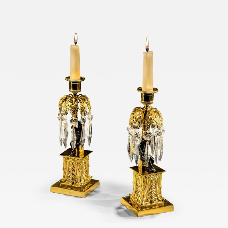 AN UNUSUAL PAIR OF GILT BRONZE MILITARY FIGURE CANDLESTICKS