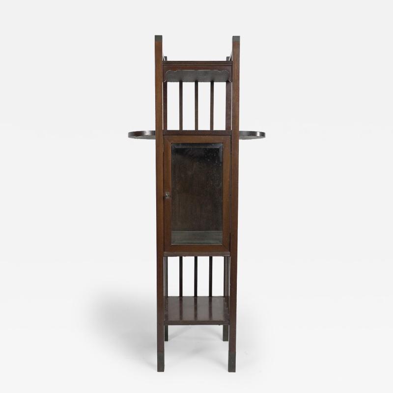 An Anglo Japanese style Mahogany side cabinet of slender form with brass sabots 