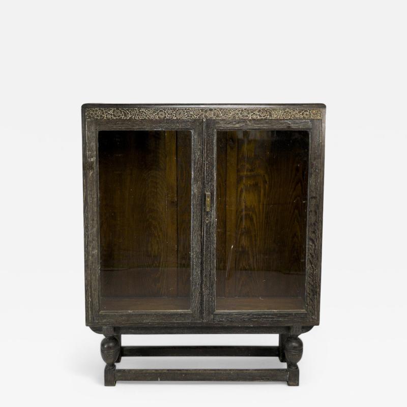 An Art Deco Dark Limed Oak Glazed Bookcase with Carved Floral Decoration