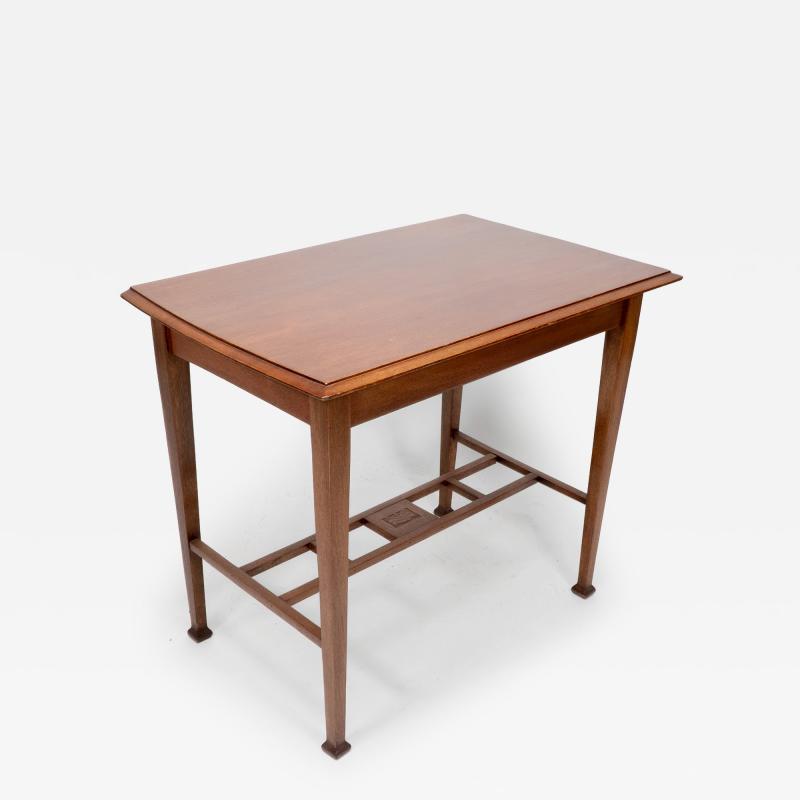 An Arts Crafts Glasgow School walnut side table w moulded subtly curving edge