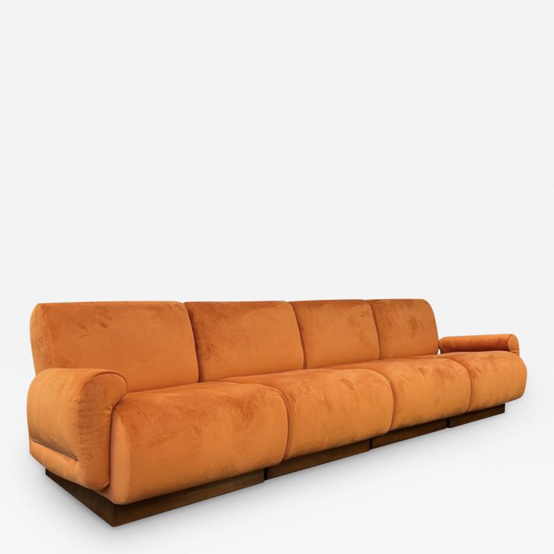 An Italian 1970s Large 4 seater sectional sofa in burnt orange velvet