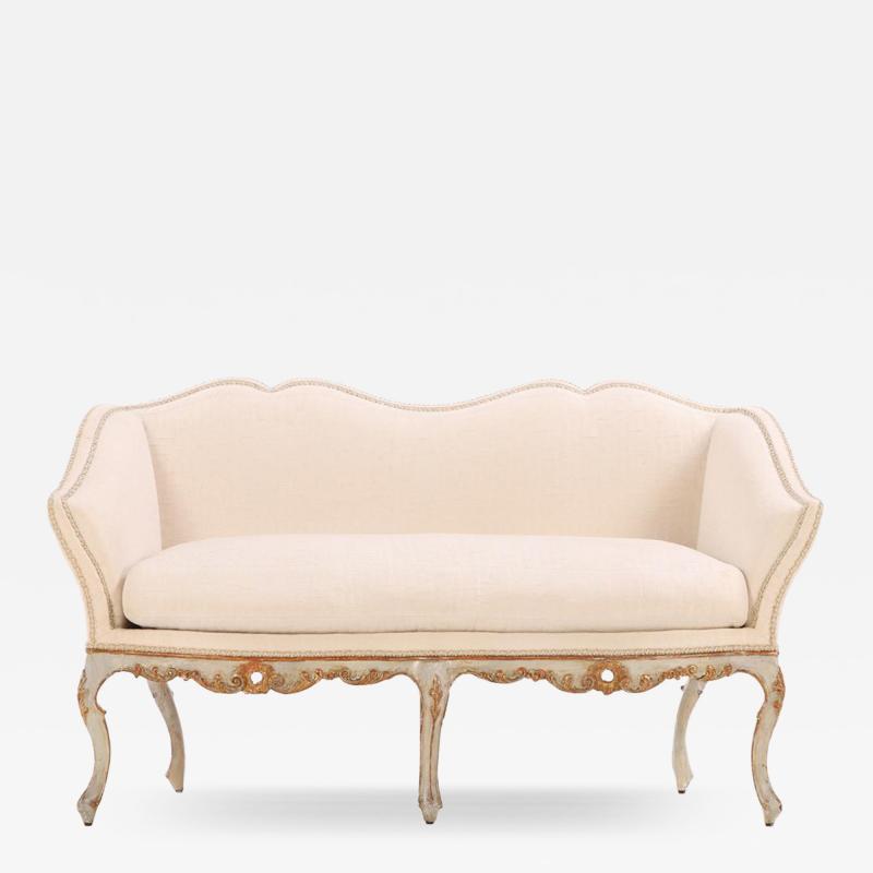 An Italian painted and carved settee 18th C in recent fabric 